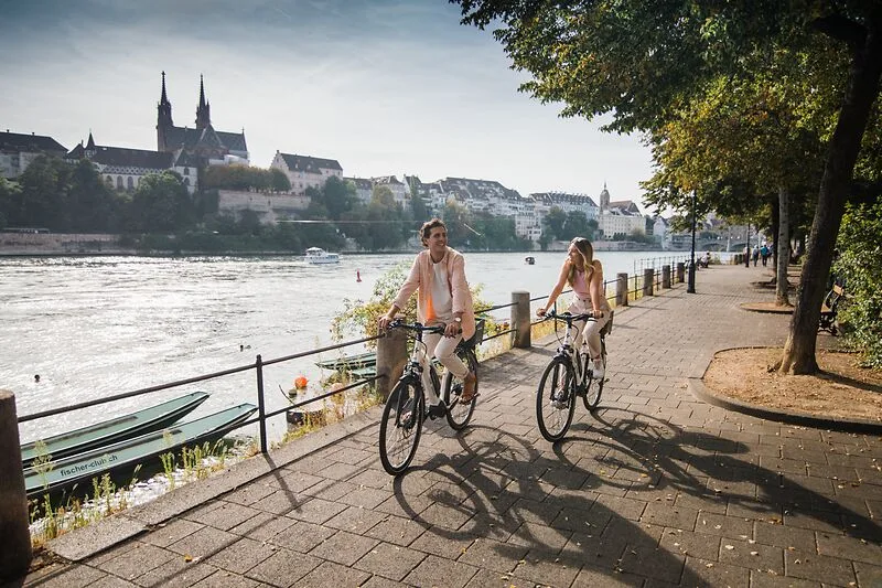 A couple biking next to the rhein in Basel 800px