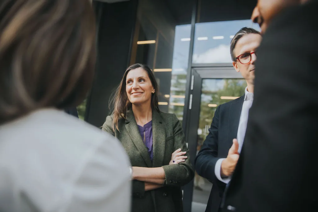 Executives talking in group and smiling